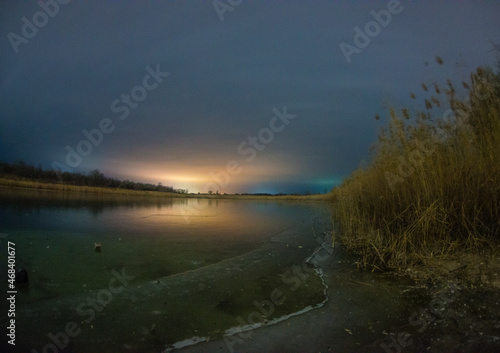 sunrise over lake forest in the night . Night landscape. Nightsky and clouds . Stars in the sky . Lights of the city  . Evening forest  . Landscapes of Ukraine . Night and morning time  © Александр Рябинин