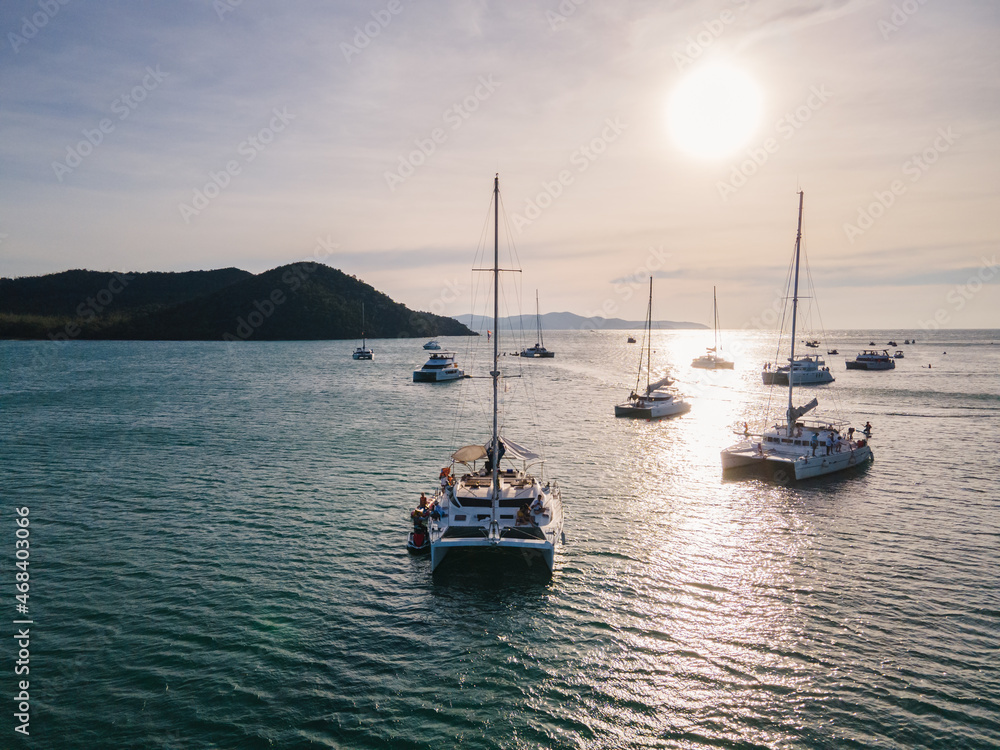 Fototapeta premium Private yacht sailing on tropical sea in the sunset