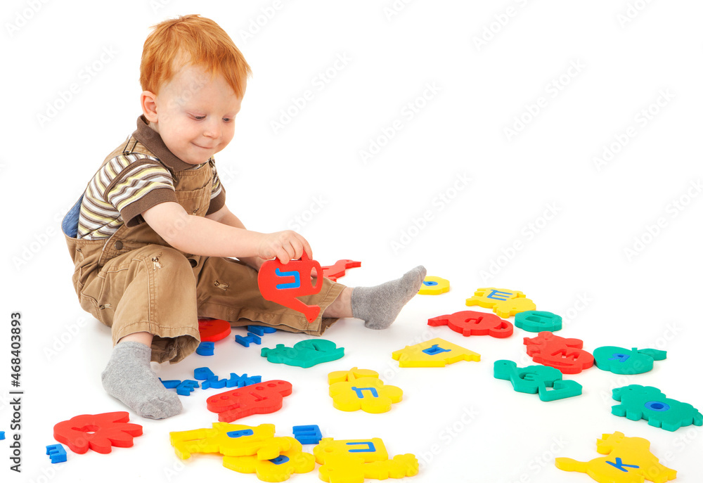 A little boy is playing with an educational puzzle A little boy is playing with an educational puzzle