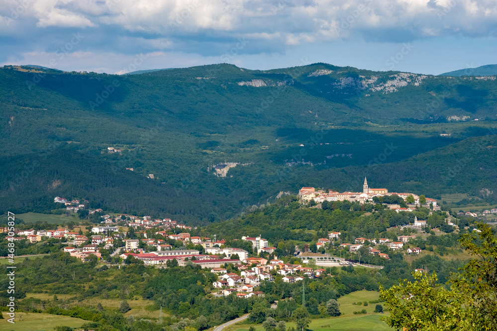 Buzet in Istria with green mountains, blue sky and white clouds