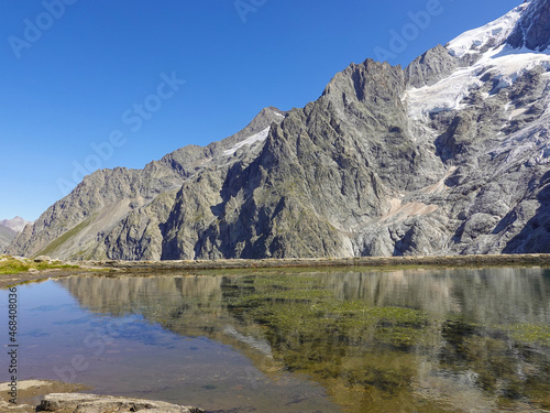 Panorama of the La Meije massif with reflection in a water reservoir