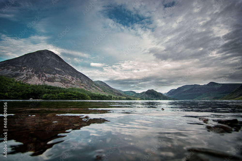 A landscape photograph looking across Crummock Water to the southern fells of Buttermere Valley in the lake District, Cumbria.