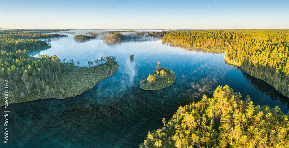 calm summer morning with fog over the lake in Karelia