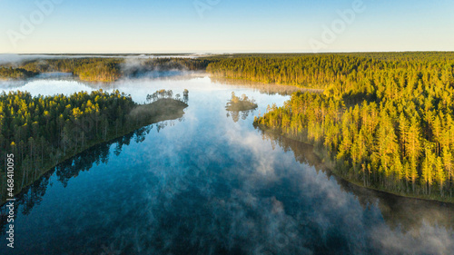 calm summer morning with fog over the lake in Karelia