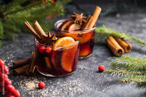 Glass mugs of mulled wine with spices and citrus fruits. Traditional hot drink or beverage, festive cocktail at X-mas or New Year