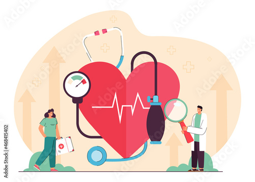 Tiny cardiology doctor and nurse examining heart, blood pressure, prescribing treatment. Medical cardiovascular checkup flat vector illustration. Anatomy, hospital, heart diseases, health care concept photo