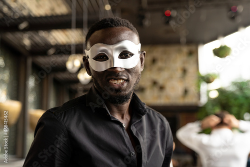 Smiling African American man wear fantasy face mask for celebration in his company © amorn