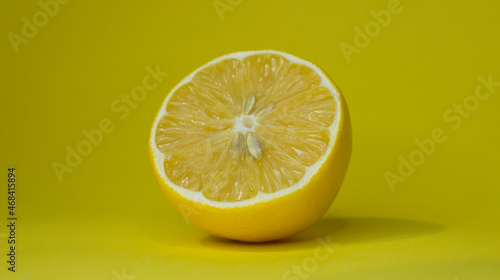 Sliced lemon on a yellow background.