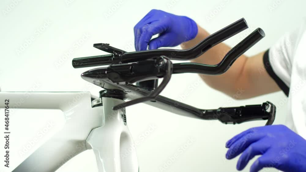 The bike mechanic installs the handles on the bike. Sports bike repair