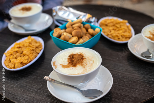 A cup of traditional Lebanese desert known as Sahlab with its usual side dishes 