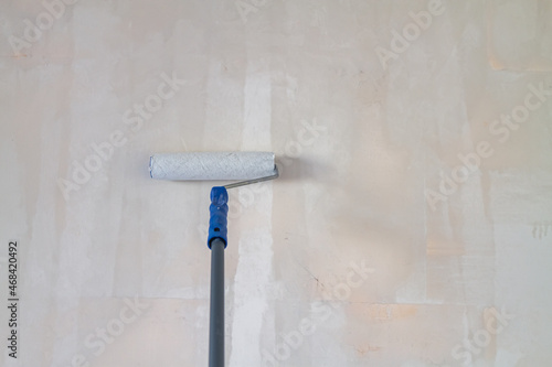 Primed with a roller with a primer putty wall before painting or gluing wallpaper photo