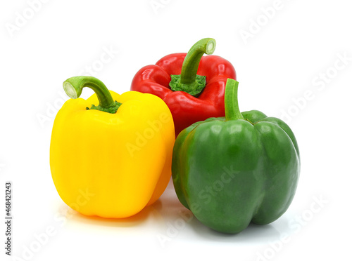 Whole yellow green red bell pepper isolated on white background.