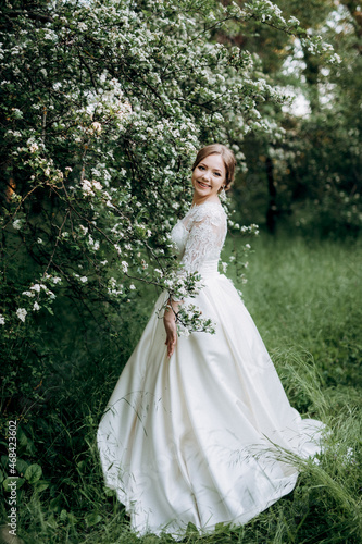 bride with a wedding bouquet in the forest