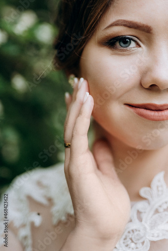 bride with a wedding bouquet in the forest photo