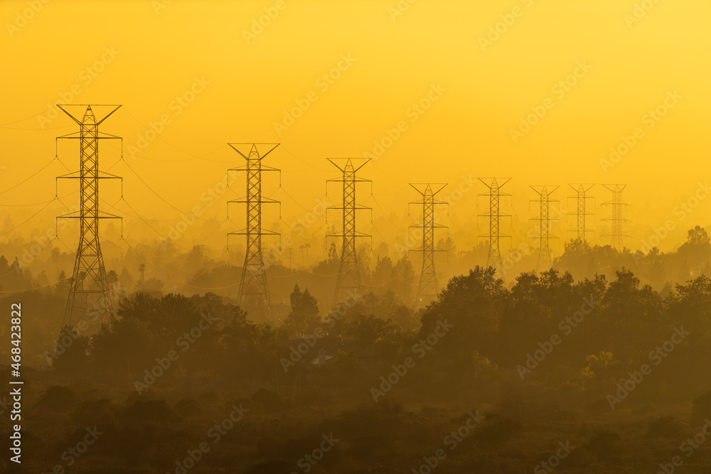 Eight Power Line Towers in Foggy Woodlands at Sunset Eight Power Line Towers in Foggy Woodlands at Sunset