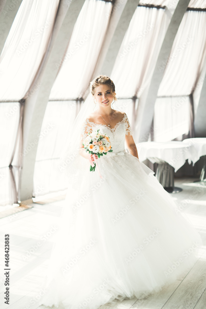 Portrait of stunning bride with long hair posing with great bouquet Portrait of stunning bride with long hair posing with great bouquet