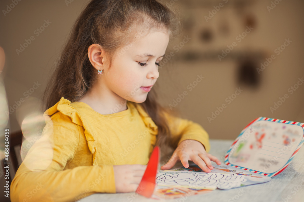 Cute little girl writes a letter to Santa Claus. Christmas concept Cute little girl writes a letter to Santa Claus. Christmas concept