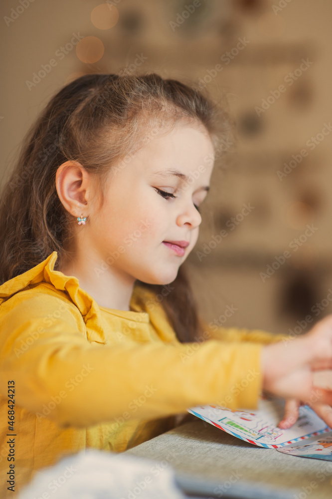Cute little girl writes a letter to Santa Claus. Christmas concept Cute little girl writes a letter to Santa Claus. Christmas concept