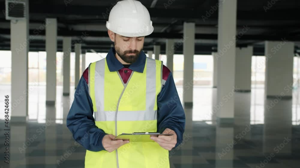 Portrait of HSE inspector checking industrial zone reading papers ...