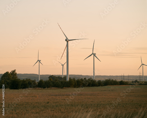 Wind turbines during sunrise. Wind farm view at sunset
