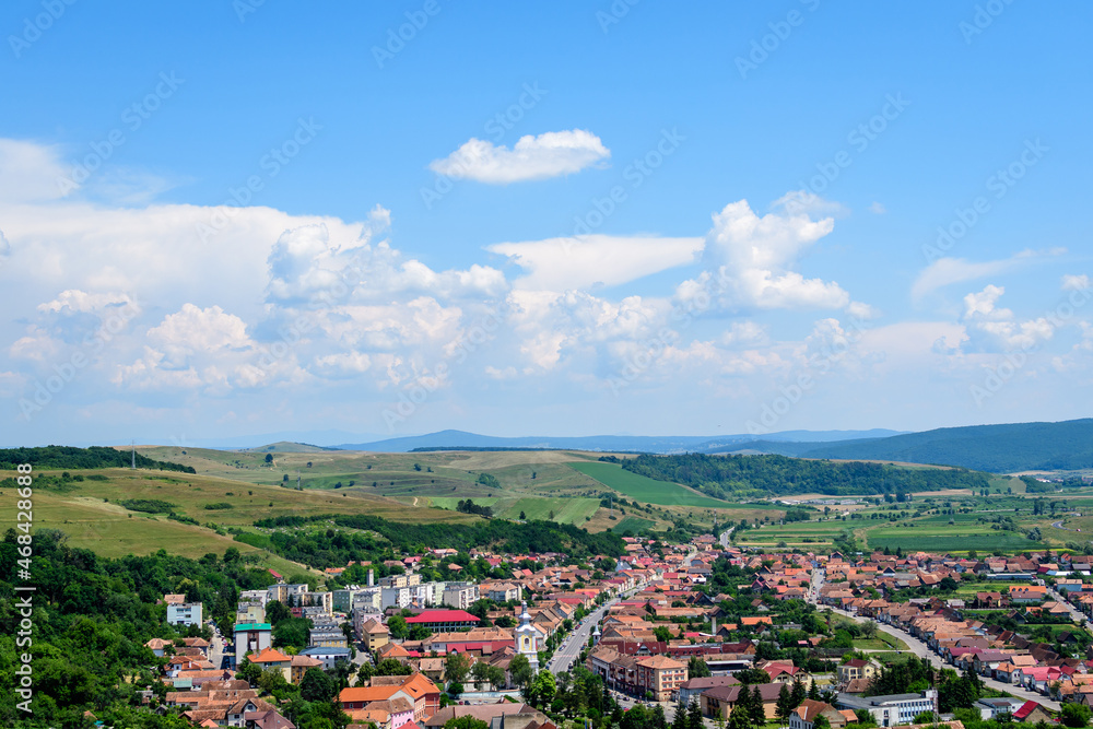 View from the stone walls at the Rupea Citadel (Cetatea Rupea) after renovation towards a small town in Brasov county, in the southern part of Transylvania (Transilvania) region, Romania in summer . View from the stone walls at the Rupea Citadel (Cetatea Rupea) after renovation towards a small town in Brasov county, in the southern part of Transylvania (Transilvania) region, Romania in summer .