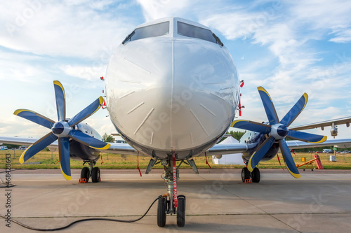 Tableau sur toile New turboprop aircraft parked at the airport, view straight ahead