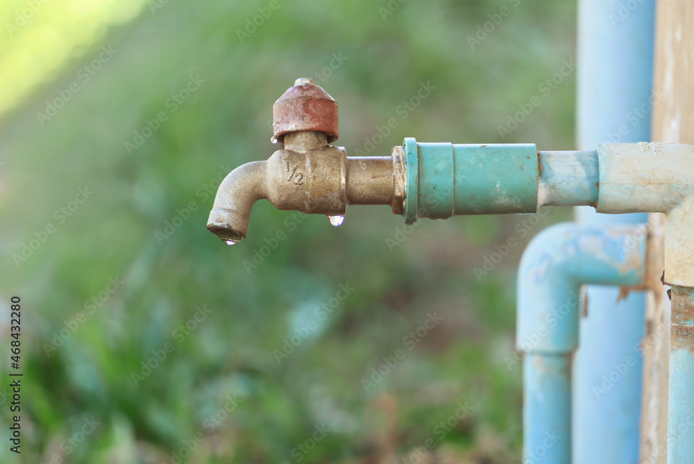 Old faucets have leaking water from broken fittings and equipment. Old faucets have leaking water from broken fittings and equipment.