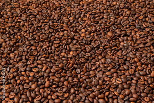 Fresh roasted coffee beans background. Selective focus. Copy space