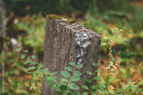 Принти на полотні A broken gray cement grave stone in green grass of an old cemetery