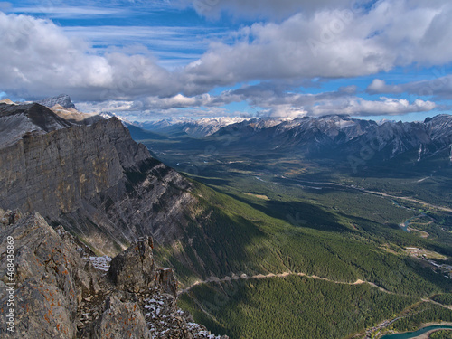Stunning panoramic view of Bow Valley in the Rocky Mountains near Canmore, Alberta, Canada on sunny day in autumn with Rundle Group massif and river.