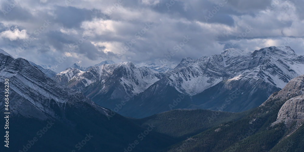 Aerial view of rugged Sundance Range in the Rocky Mountains near Canmore, Alberta, Canada with snow-capped Mount Turbulent viewed from Ha Ling Peak. Aerial view of rugged Sundance Range in the Rocky Mountains near Canmore, Alberta, Canada with snow-capped Mount Turbulent viewed from Ha Ling Peak.