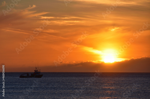 Sunset on the sea with clouds and a boat on the beach of Doniños de Ferrol © nando espiñeira