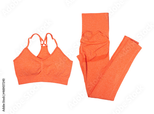 Womens sports set leggings and bra for yoga and fitness orange isolated on white background.