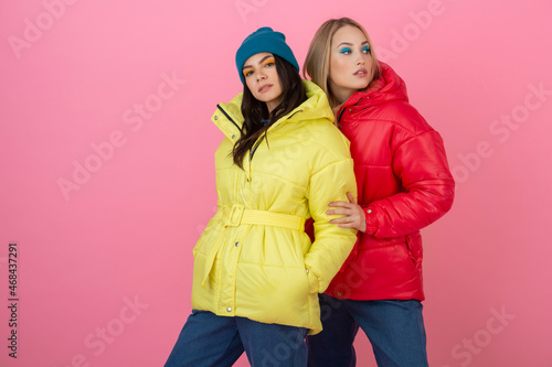 pretty women friends in colorful down jacket