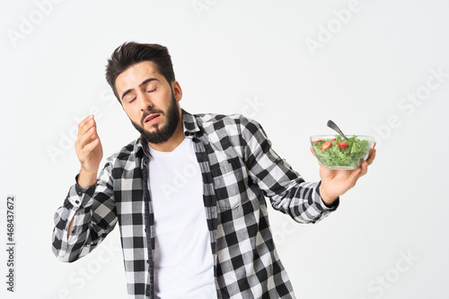 Cheerful man in plaid shirt plate with salad healthy food