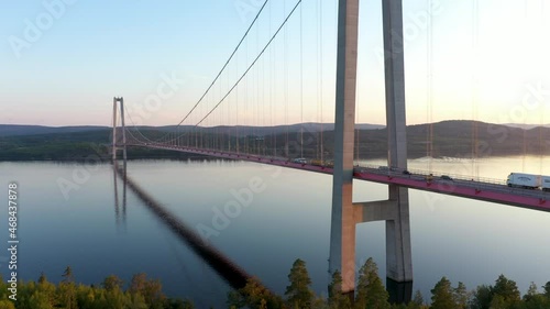 Traffic on High Coast bridge in Sweden. Aerial drone view of the famous bridge in northern Sweden. Truck and cars on bridge. 