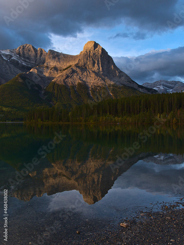 View of majestic mountain Ha Ling Peak in the Rocky Mountains near Canmore  Kananaskis Country  Alberta  Canada after sunrise reflected in water.