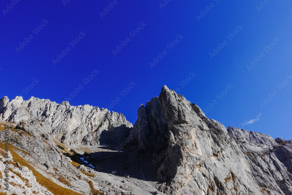 peaky rocky mountains while hiking in beautiful weather in autumn panorama