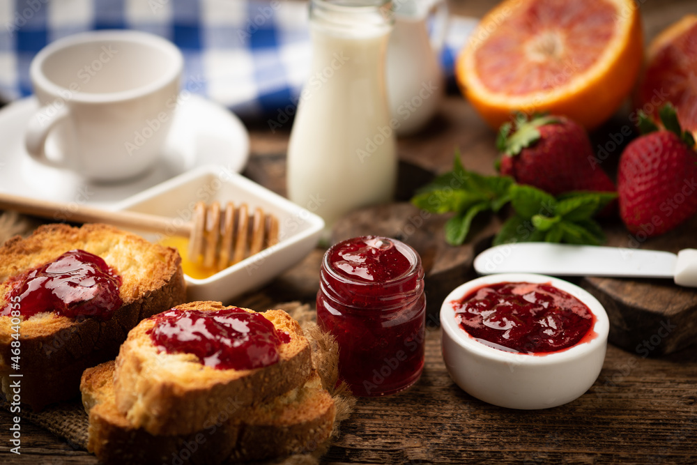 Strawberries with jam and glass of milk. Natural breakfast, rustic wooden Strawberries with jam and glass of milk. Natural breakfast, rustic wooden