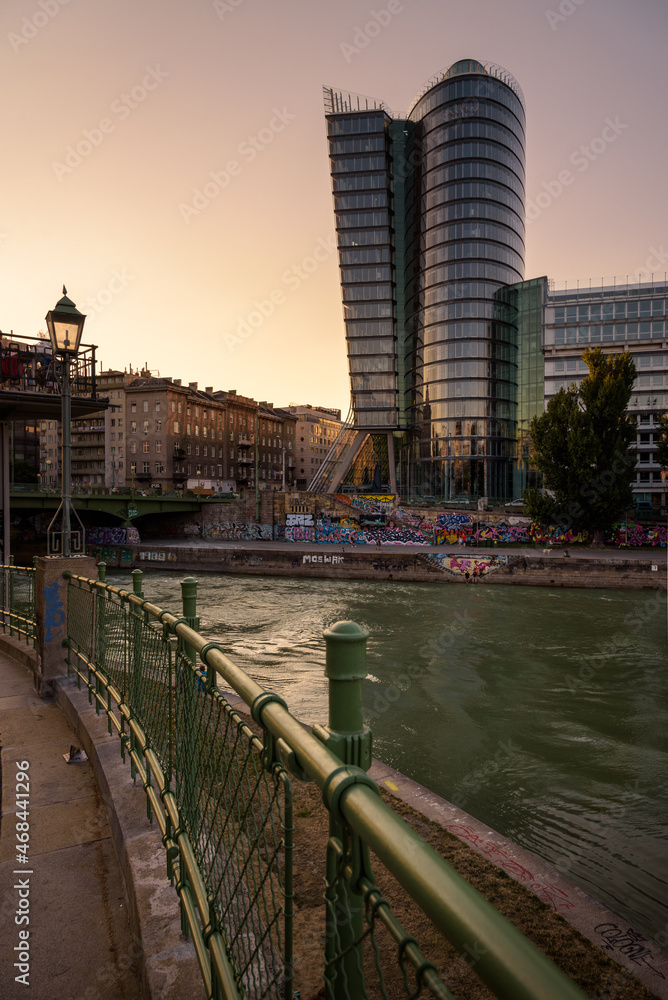 Fototapeta premium View of Uniqa Tower building and Danube canal at sunset, Vienna, Austria