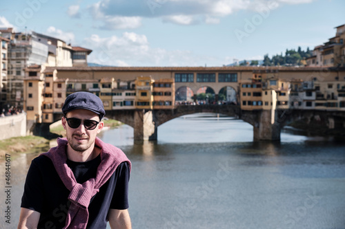 a man with sunglasses and a beret on the Ponte Vecchio