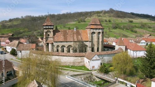 Aerial footage of a Transylvanian fortified church at Valea Viilor, in Sibiu county, Romania. Video shot from a drone while picking altitude. Fortified church from Biertan assembly. photo