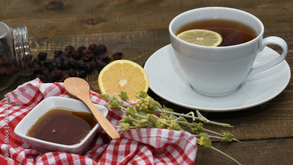 Herbal tea with lemon, honey and other herbs on wooden background. Herbal tea with lemon, honey and other herbs on wooden background.
