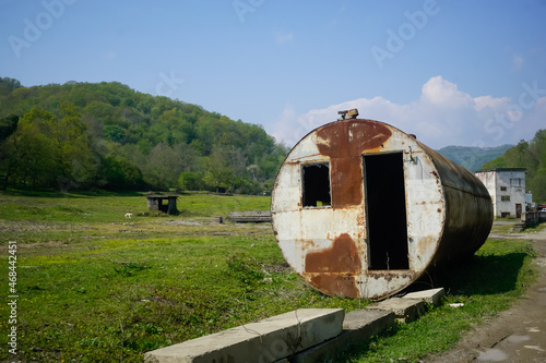 Large round abandoned container in the meadow © Pavel