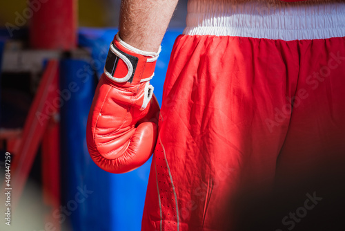 boxer in the corner of the ring in red shorts and gloves is large © Uladzimir
