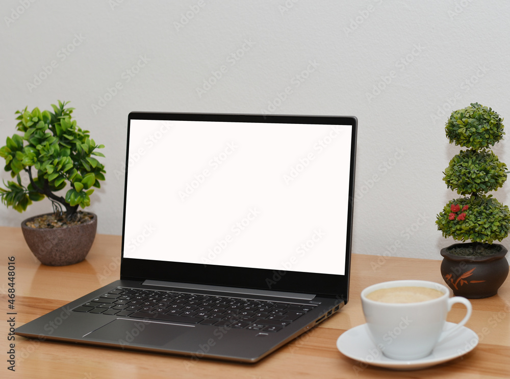 Mockup image of laptop with blank white screen on wooden table in modern space Mockup image of laptop with blank white screen on wooden table in modern space