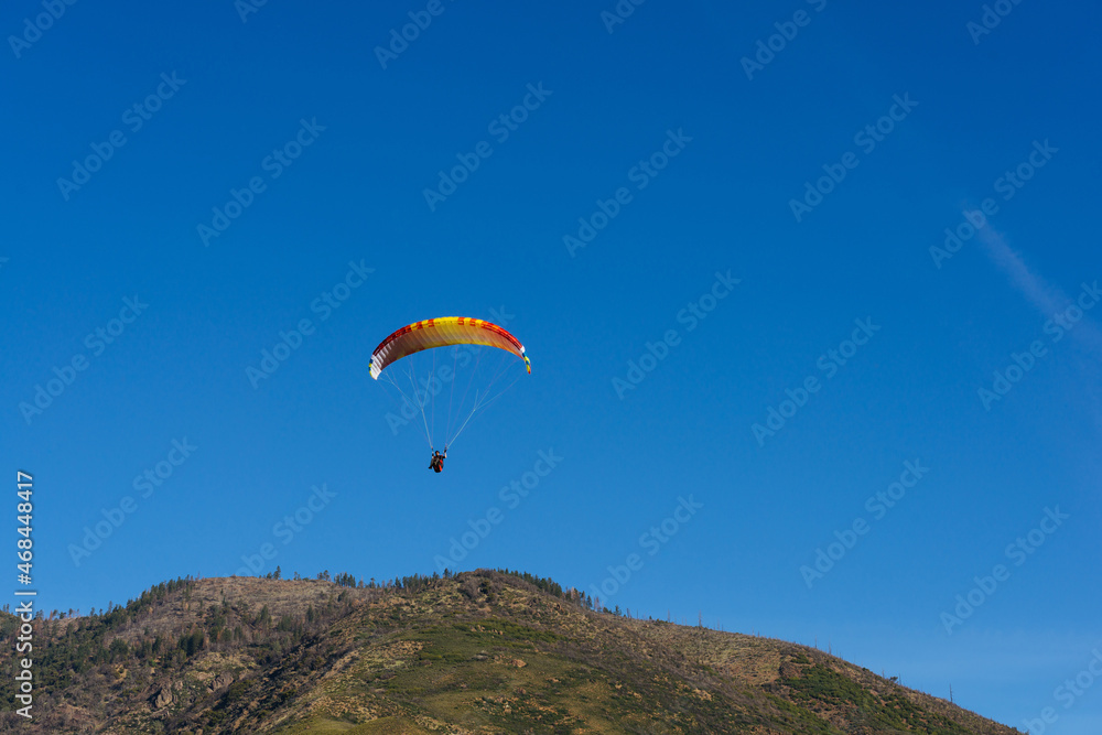 Paragliding Pilot Flying a Paraglider Paragliding Pilot Flying a Paraglider