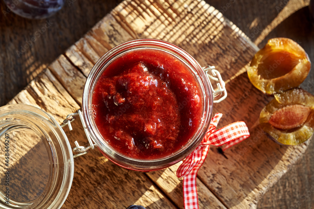 Klevela - a special kind of plum jam, with fresh plums in the background Klevela - a special kind of plum jam, with fresh plums in the background