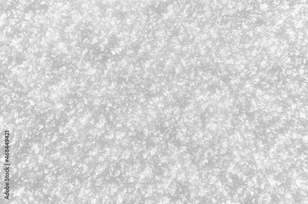 Snowy white background. Close-up snowflakes texture.