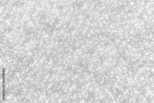 Snowy white background. Close-up snowflakes texture.